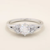 14k solid gold dainty engagement ring with a round moissanite center stone and tiny accent stones on the side. A delicate and timeless design. Perfect for minimal yet meaningful proposals.