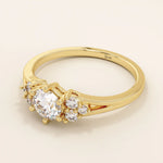14k solid gold dainty engagement ring with a round moissanite center stone and tiny accent stones on the side. A delicate and timeless design. Perfect for minimal yet meaningful proposals.
