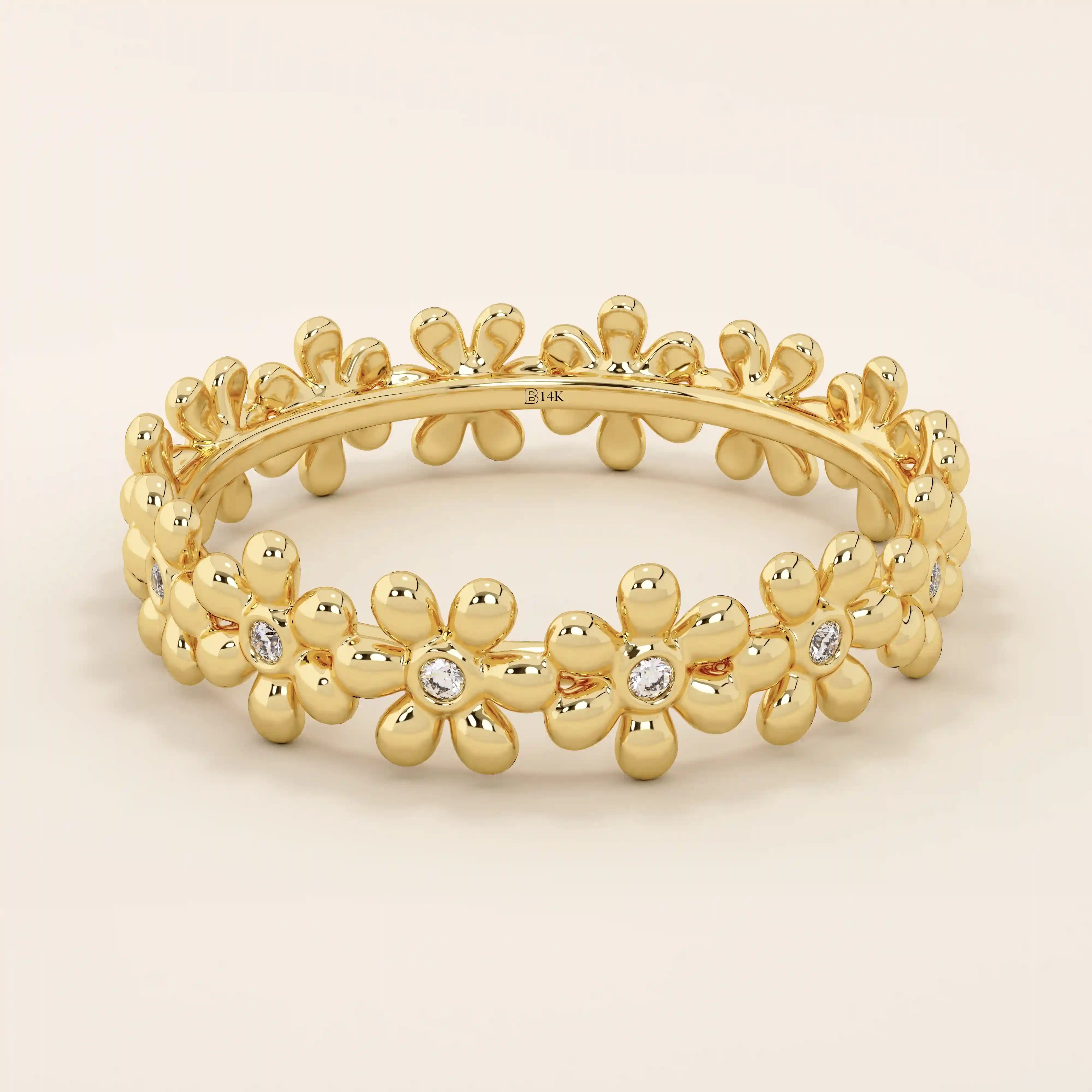 14k solid gold eternity band ring adorned with tiny daisy flower motifs. Delicate and whimsical statement jewelry for women.