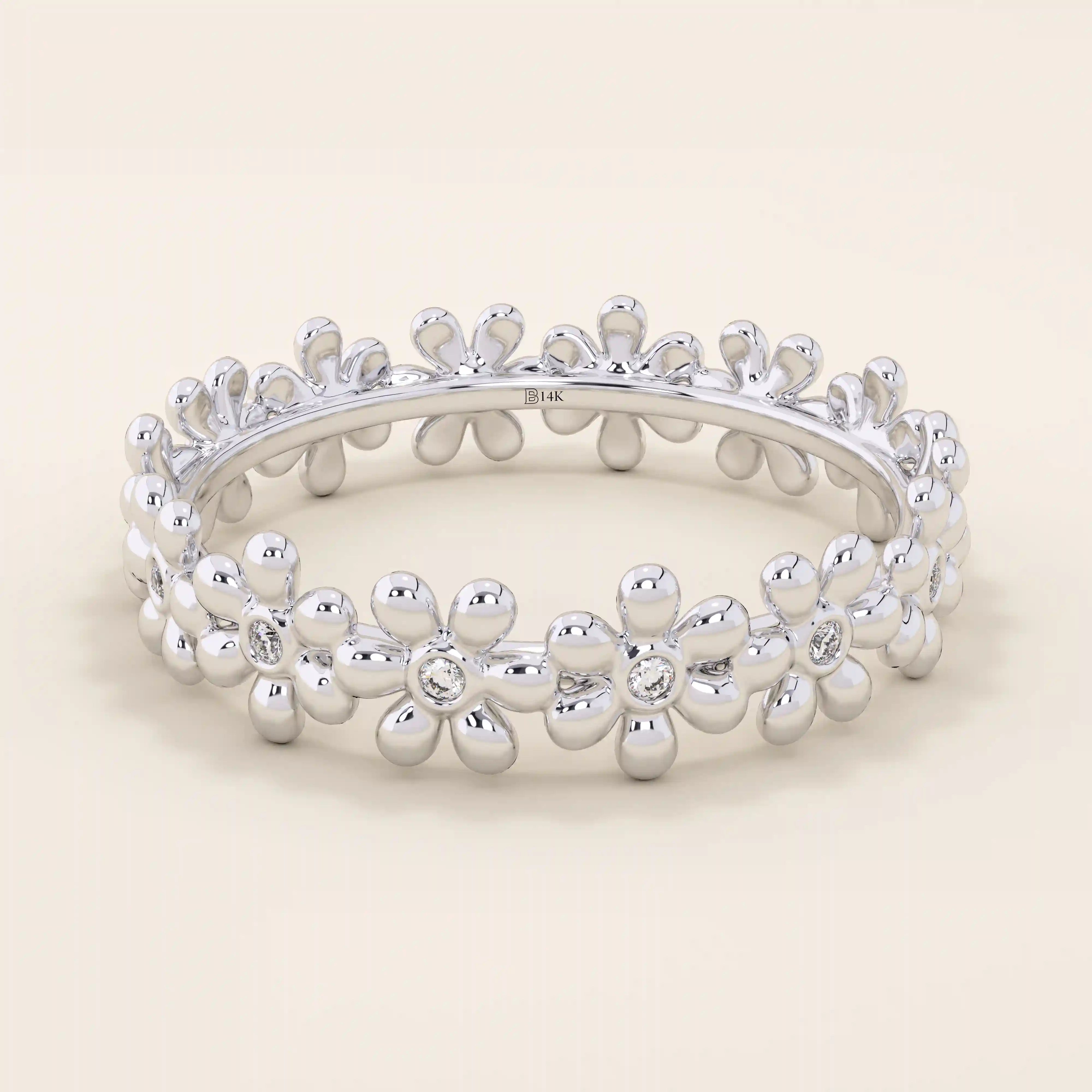 14k solid gold eternity band ring adorned with tiny daisy flower motifs. Delicate and whimsical statement jewelry for women.