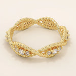 14k solid gold eternity statement ring with a unique twisted band design, adorned with sparkling moissanites. Elegant and modern.