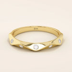 14k solid gold faceted band wedding ring adorned with tiny moissanite stones. Minimalist and sparkling design for everyday wear or stacking.