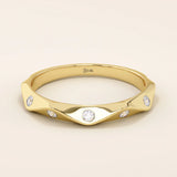 14k solid gold faceted band wedding ring adorned with tiny moissanite stones. Minimalist and sparkling design for everyday wear or stacking.