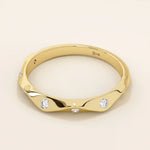 14k solid gold faceted band wedding ring adorned with tiny moissanite stones. Minimalist and sparkling design for everyday wear or stacking.