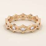 14k solid gold geometric eternity band ring featuring rhombus shapes adorned with sparkling moissanites. Bold and modern design.