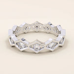 14k solid gold geometric eternity band ring featuring rhombus shapes adorned with sparkling moissanites. Bold and modern design.