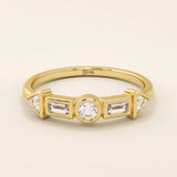 14k solid gold half eternity statement ring featuring bezel-set mixed cut moissanite stones. Modern and elegant design.