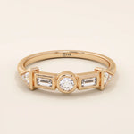 14k solid gold half eternity statement ring featuring bezel-set mixed cut moissanite stones. Modern and elegant design.