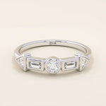 14k solid gold half eternity statement ring featuring bezel-set mixed cut moissanite stones. Modern and elegant design.