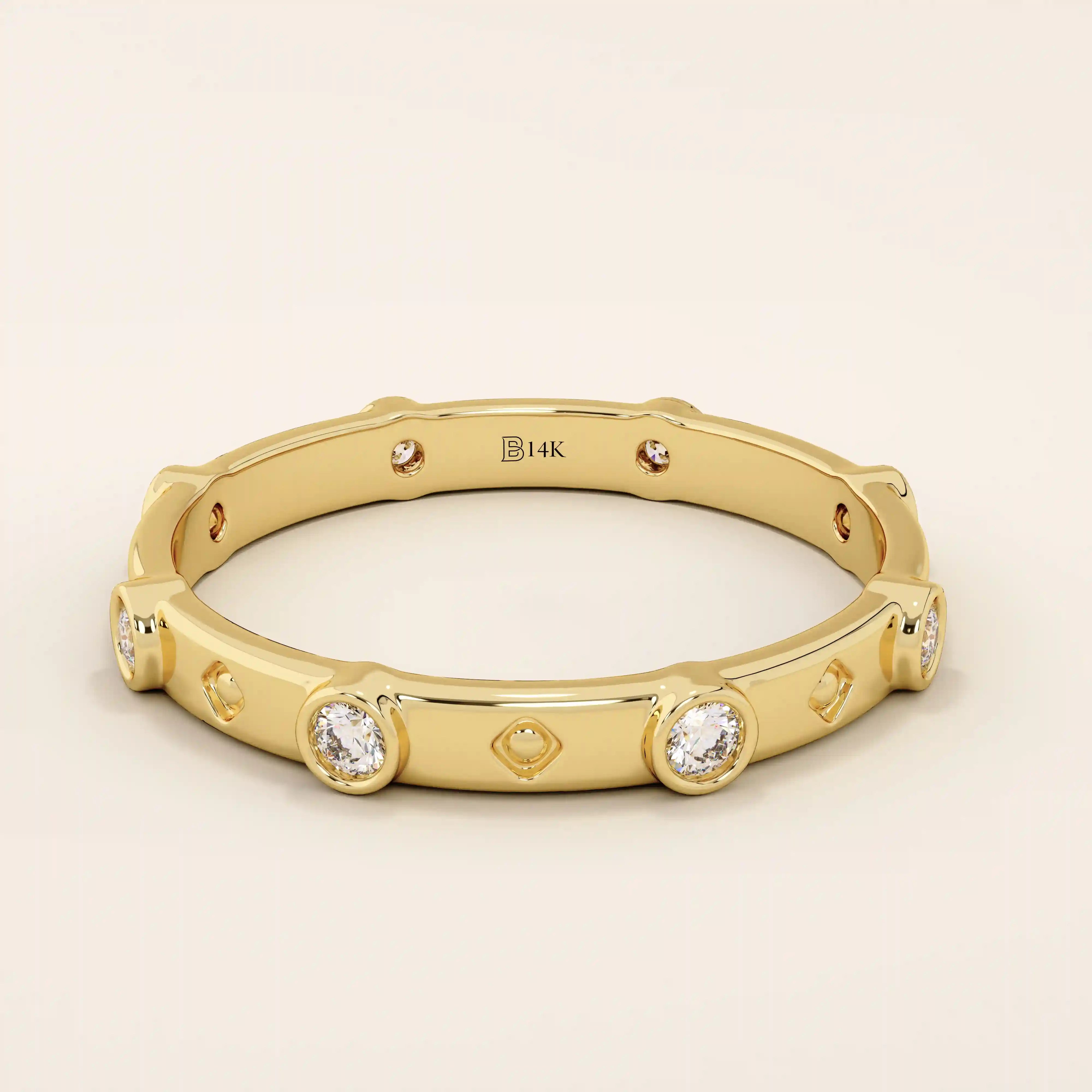 14k solid gold minimalist band ring with bezel-set moissanites around the band. Modern eternity statement jewelry for women.