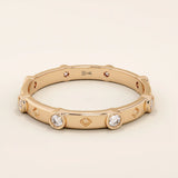 14k solid gold minimalist band ring with bezel-set moissanites around the band. Modern eternity statement jewelry for women.