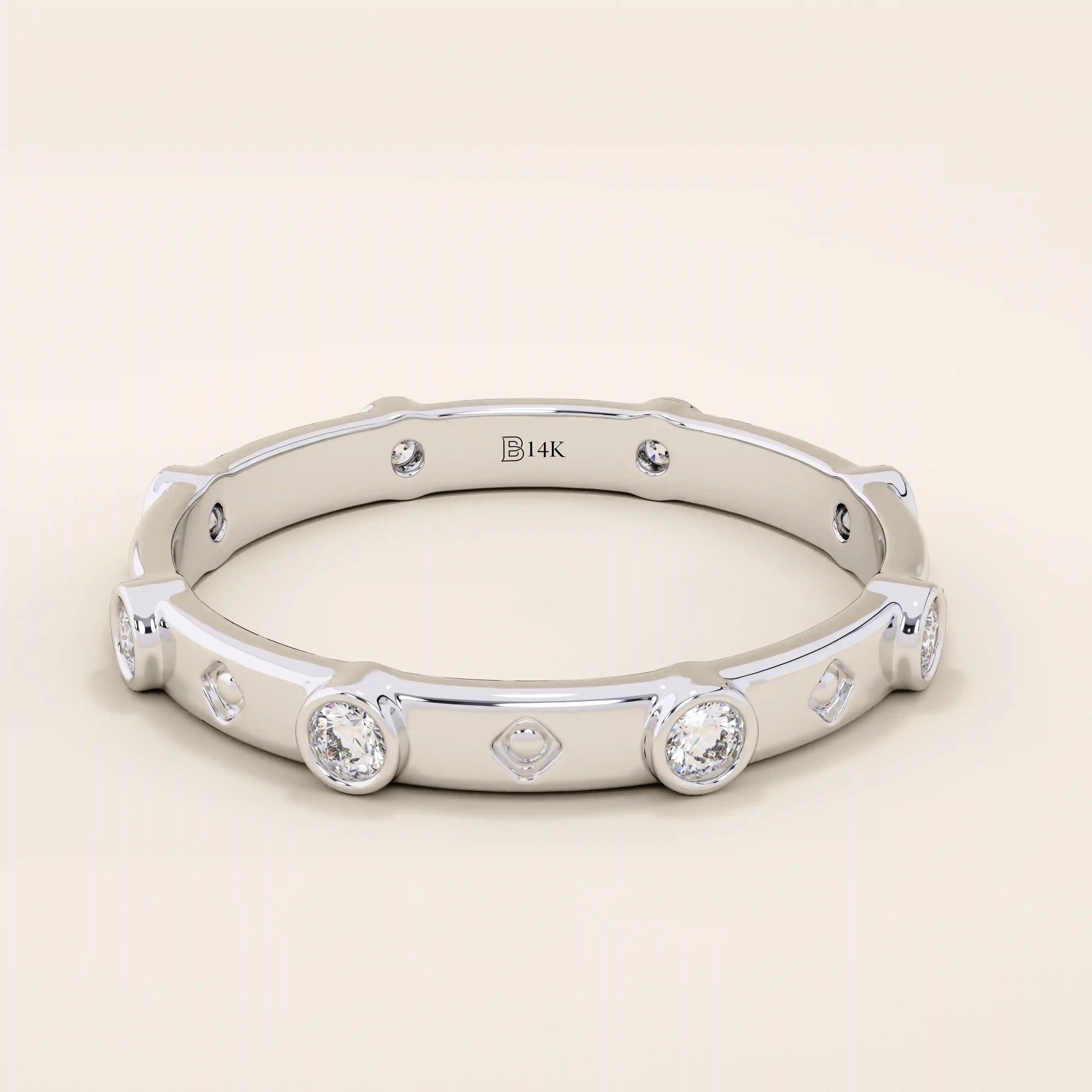 14k solid gold minimalist band ring with bezel-set moissanites around the band. Modern eternity statement jewelry for women.