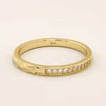 14k solid gold nature-inspired two-sided wedding ring with leaf engravings on one side and channel-set moissanites on the other. Unique and elegant design for women.