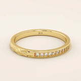 14k solid gold nature-inspired two-sided wedding ring with leaf engravings on one side and channel-set moissanites on the other. Unique and elegant design for women.