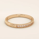 14k solid gold nature-inspired two-sided wedding ring with leaf engravings on one side and channel-set moissanites on the other. Unique and elegant design for women.