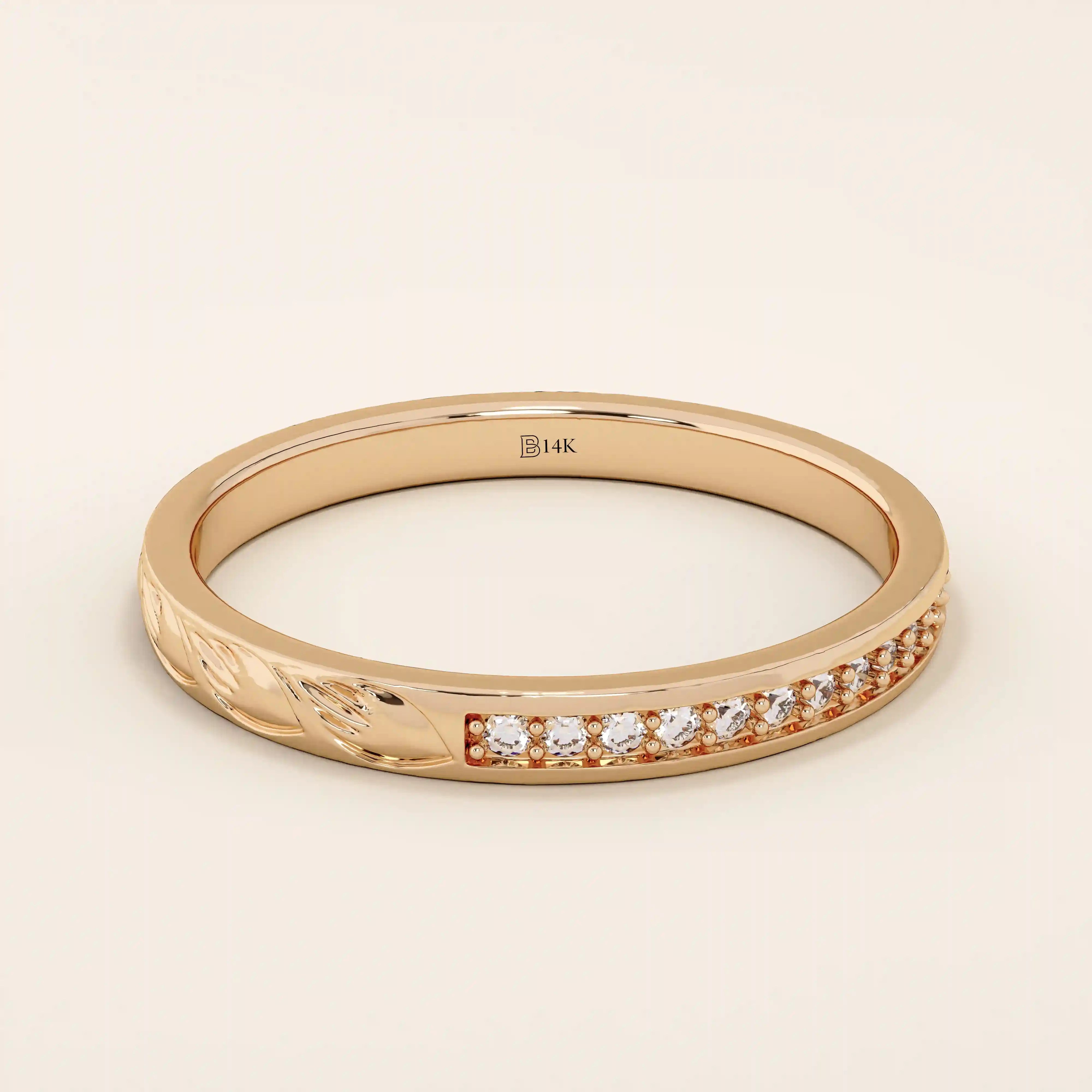 14k solid gold nature-inspired two-sided wedding ring with leaf engravings on one side and channel-set moissanites on the other. Unique and elegant design for women.