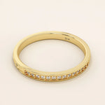 14k solid gold nature-inspired two-sided wedding ring with leaf engravings on one side and channel-set moissanites on the other. Unique and elegant design for women.