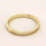 14k solid gold nature-inspired two-sided wedding ring with leaf engravings on one side and channel-set moissanites on the other. Unique and elegant design for women.