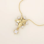 14k solid gold necklace featuring a 5-petal flower design with a dangling moissanite. Feminine and delicate floral jewelry. Ideal for everyday elegance.