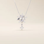 14k solid gold necklace featuring a 5-petal flower design with a dangling moissanite. Feminine and delicate floral jewelry. Ideal for everyday elegance.
