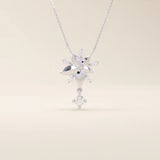 14k solid gold necklace featuring a 5-petal flower design with a dangling moissanite. Feminine and delicate floral jewelry. Ideal for everyday elegance.