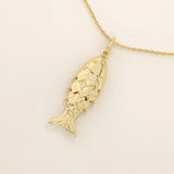 14k solid gold necklace featuring a minimalist fish design. Symbolic and playful gold jewelry. Ideal for everyday wear or gifting.