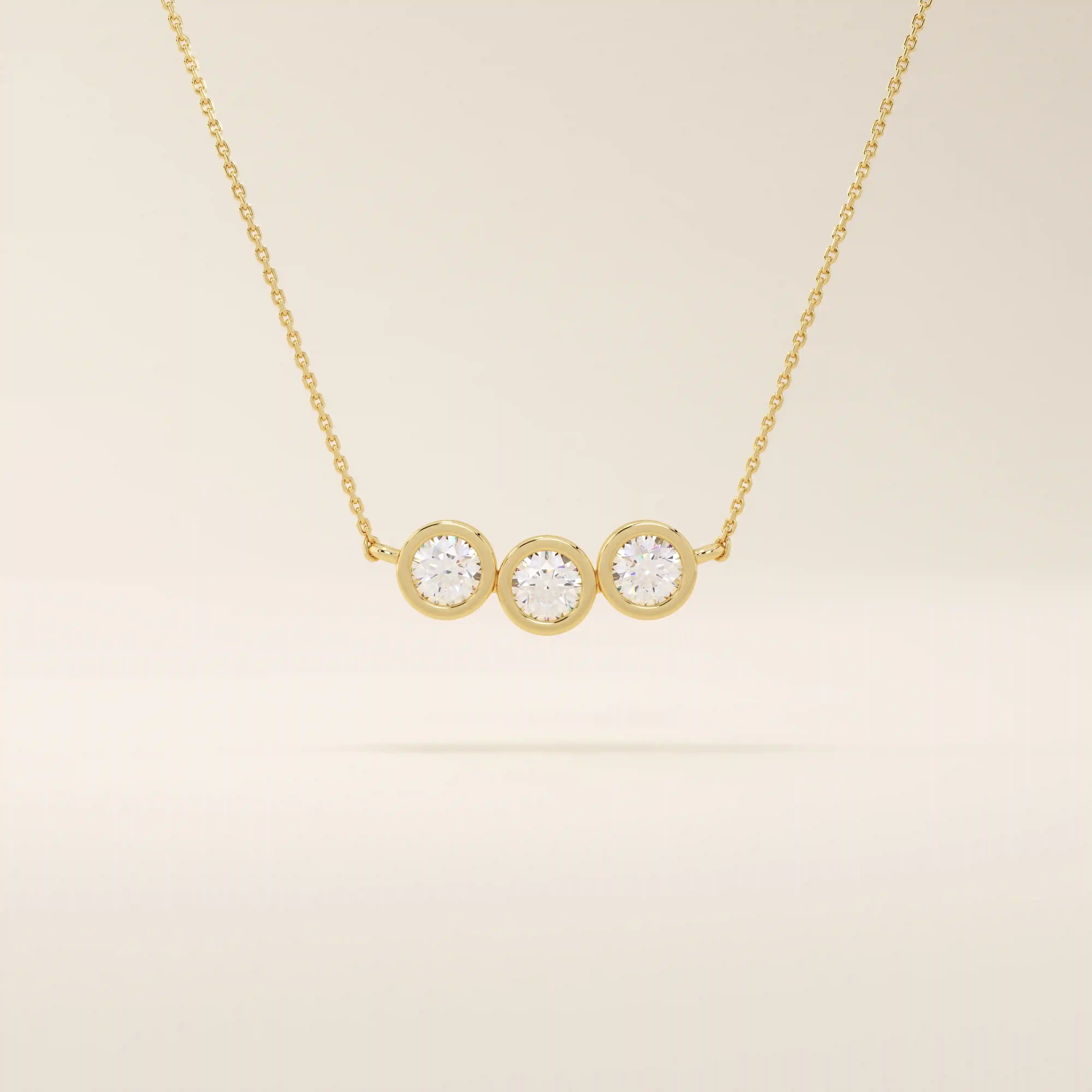 14k solid gold necklace featuring three bezel-set moissanite stones. A minimalist and stackable design perfect for layering everyday jewelry.
