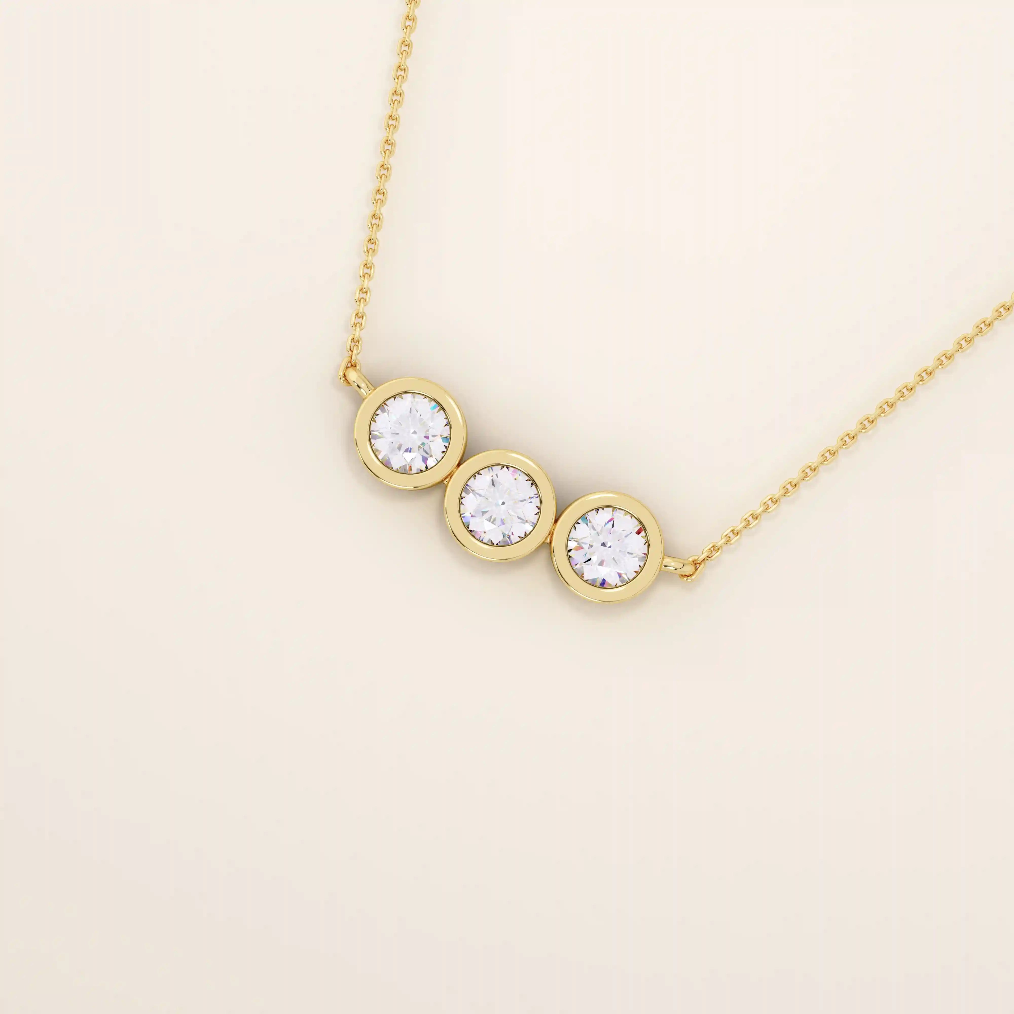 14k solid gold necklace featuring three bezel-set moissanite stones. A minimalist and stackable design perfect for layering everyday jewelry.