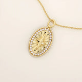 14k solid gold oval compass pendant necklace with pave moissanite stones around and a 4-point star design in the center. Elegant and symbolic gold jewelry. Perfect for daily wear.