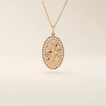 14k solid gold oval compass pendant necklace with pave moissanite stones around and a 4-point star design in the center. Elegant and symbolic gold jewelry. Perfect for daily wear.