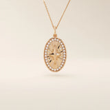 14k solid gold oval compass pendant necklace with pave moissanite stones around and a 4-point star design in the center. Elegant and symbolic gold jewelry. Perfect for daily wear.