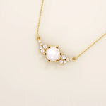 14k solid gold pearl necklace featuring moissanite clusters on both sides of the center pearl. Elegant and modern pearl jewelry. Perfect for minimalist daily wear.
