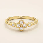 14k solid gold pinky signet ring with a beaded band and clover-shaped moissanite centerpiece. A delicate and symbolic design for women.