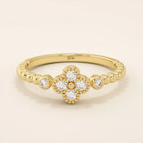 14k solid gold pinky signet ring with a beaded band and clover-shaped moissanite centerpiece. A delicate and symbolic design for women.