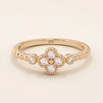 14k solid gold pinky signet ring with a beaded band and clover-shaped moissanite centerpiece. A delicate and symbolic design for women.