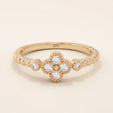 14k solid gold pinky signet ring with a beaded band and clover-shaped moissanite centerpiece. A delicate and symbolic design for women.