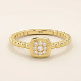 14k solid gold pinky signet ring with a square face and textured beaded band. A modern and elegant minimalist design.