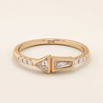 14k solid gold promise ring featuring tapered baguette and triangle-cut moissanites in bezel settings. A modern geometric design with elegant sparkle.