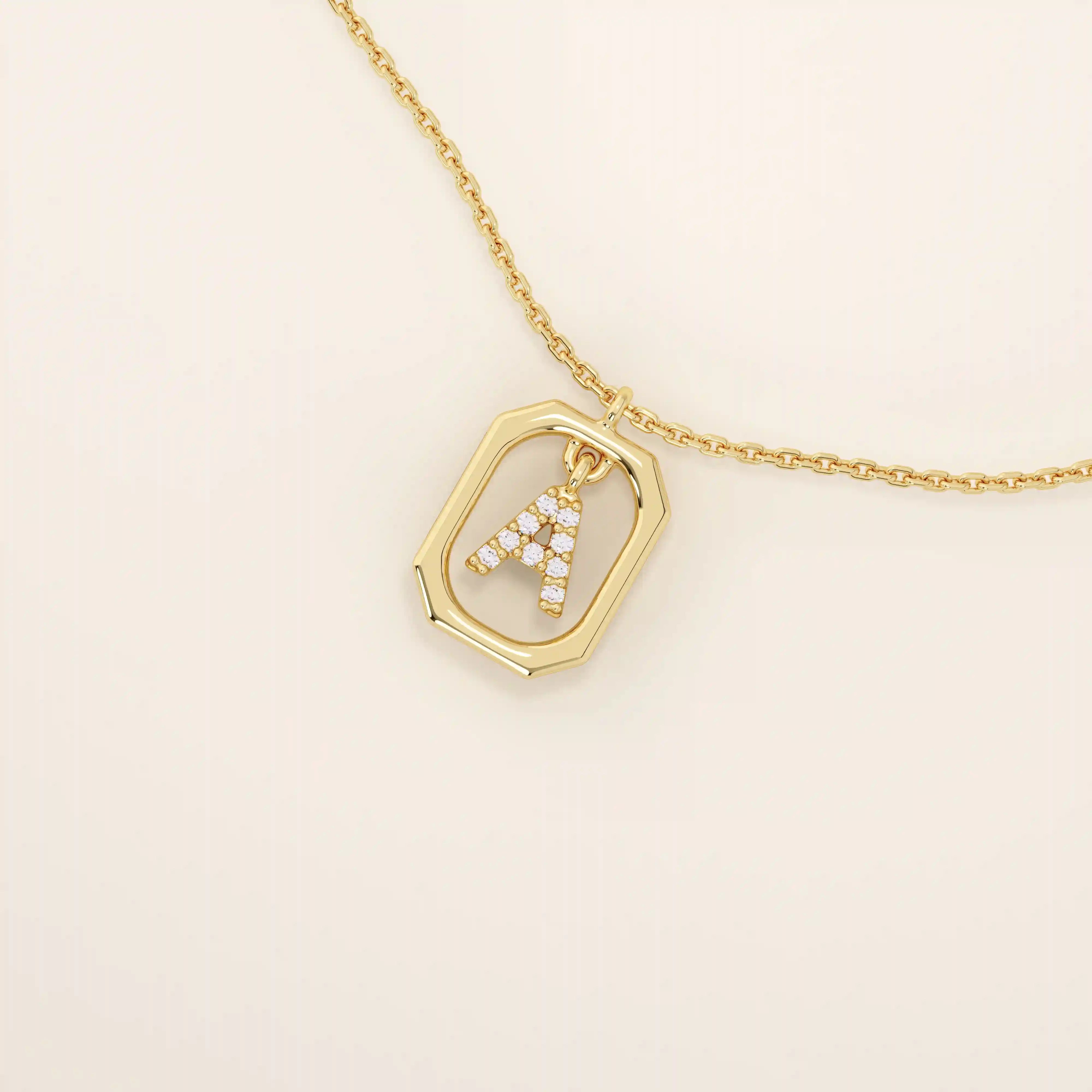 14k solid gold rectangle-shaped necklace featuring a personalized dangling initial letter. A modern and customizable everyday accessory.