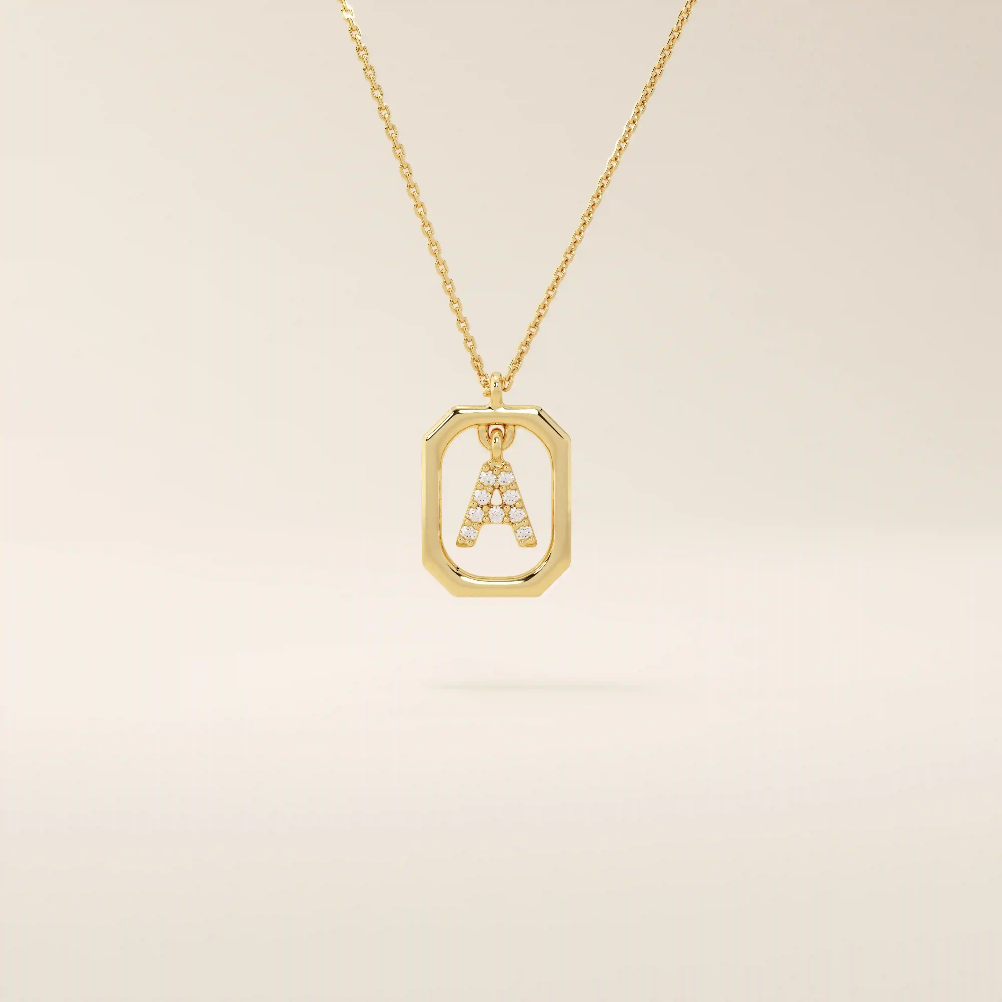 14k solid gold rectangle-shaped necklace featuring a personalized dangling initial letter. A modern and customizable everyday accessory.