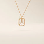 14k solid gold rectangle-shaped necklace featuring a personalized dangling initial letter. A modern and customizable everyday accessory.