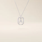 14k solid gold rectangle-shaped necklace featuring a personalized dangling initial letter. A modern and customizable everyday accessory.