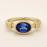 14k solid gold ring with bezel set oval sapphire and accent moissanites. A vintage-inspired solitaire gemstone ring with timeless charm.