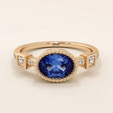 14k solid gold ring with bezel set oval sapphire and accent moissanites. A vintage-inspired solitaire gemstone ring with timeless charm.