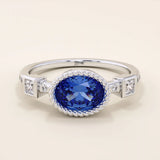 14k solid gold ring with bezel set oval sapphire and accent moissanites. A vintage-inspired solitaire gemstone ring with timeless charm.