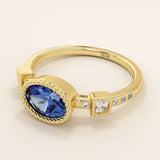 14k solid gold ring with bezel set oval sapphire and accent moissanites. A vintage-inspired solitaire gemstone ring with timeless charm.