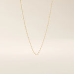 14k solid gold rolo chain necklace with round interlocking links and polished shine. A classic and sturdy gold chain. Great for everyday wear or stacking.