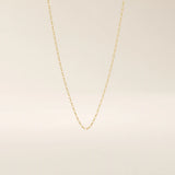14k solid gold rolo chain necklace with round interlocking links and polished shine. A classic and sturdy gold chain. Great for everyday wear or stacking.