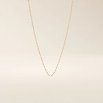 14k solid gold rolo chain necklace with round interlocking links and polished shine. A classic and sturdy gold chain. Great for everyday wear or stacking.