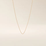 14k solid gold rolo chain necklace with round interlocking links and polished shine. A classic and sturdy gold chain. Great for everyday wear or stacking.